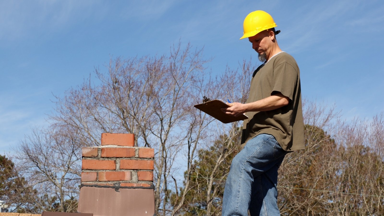 Inspector examining a roof for wear and damage